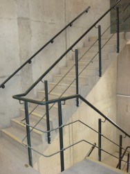 Photo of handrail running up staircase.
