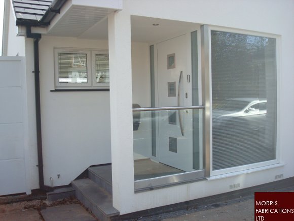 Frameless glass balustrade around porch.