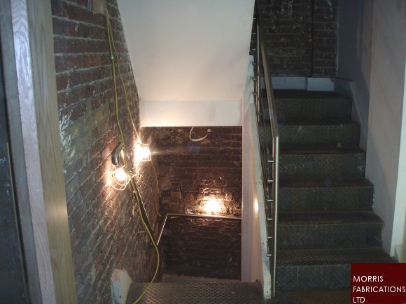 Photo of staircase with stainless steel handrail.