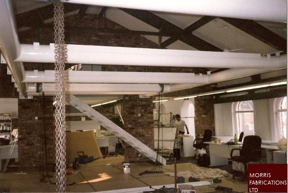 Photo of a mezzanine floor being lifted in position.