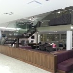 Airport lounge steel staircase with frameless glass balustrade