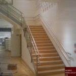 Steel stairs with wood covering and stainless steel balustrade