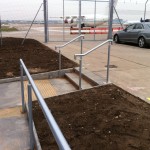 Powder coated uprights with plascoat not cold to touch top rail balustrade up ramp and steps at airport