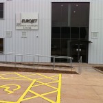 Powder coated uprights with plascoat not cold to touch top rail balustrade up ramp and steps at airport