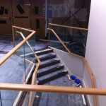 Frameless glass balustrade with timber top rail