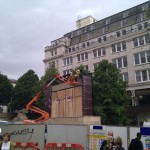 Using cherry picker to install cladding to TV screen