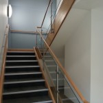 Stainless steel balustrade with timber top rail and 10mm toughened glass infill panels