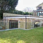 Frameless glass balustrade around garden terrace roof