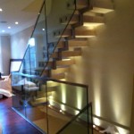 Frameless glazing balustrade up stairs with stainless steel capping