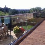 Base fixed aluminium U-channel with 15mm toughened glass and stainless steel slotted tube top rail