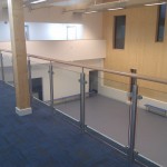 Stainless steel balustrade with timber top rail and glass infill panels