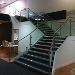 Stainless steel balustrade with glass infill panels up staircase