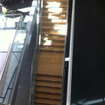 Frameless glass balustrade with stainless steel slotted tube top rail to stairs