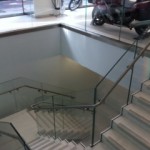 Steel staircase finished in terrazzo with frameless glass balustrade