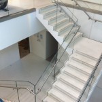 Steel staircase with terrazzo and frameless glass balustrade