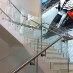 Steel staircase with terrazzo and frameless glass balustrade