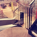 Curved staircase with frameless glass balustrade at Paperchase Glasgow