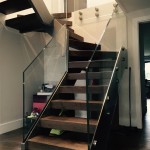 Steel staircase with timber treads and frameless glass balustrade