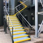Steel staircase powder coated green with stainless steel balustrade