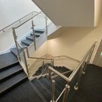 Stainless steel glass balustrade with stainless steel wall rail
